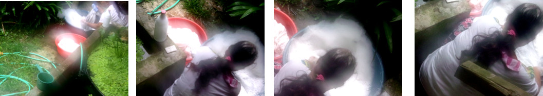 Images of woman washing cloths in
        tropical backyard