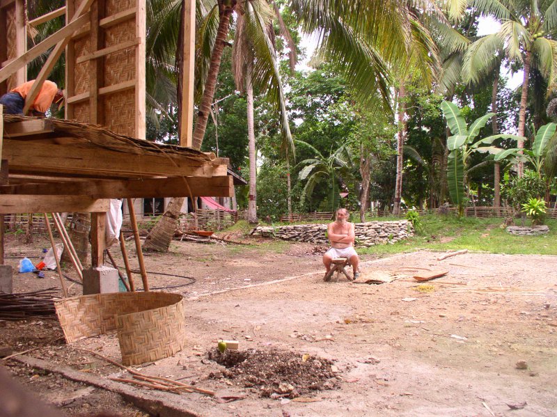 Image of workers
        -with boss sitting watching